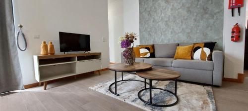 a living room with a couch and a table at Villa City in Funchal