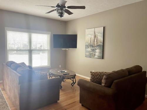a living room with a couch and a table at Bay View Condo 3 in Sodus Point