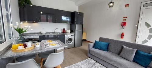 a living room with a couch and a table with food on it at Villa City in Funchal