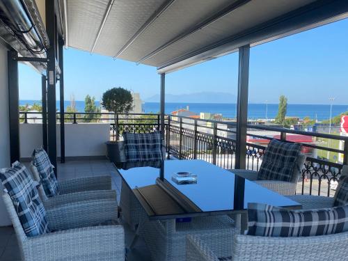 a patio with a table and chairs on a balcony at ZEN Apartments in Alexandroupoli