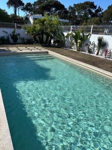 a swimming pool with blue water in a yard at Sunset Cabedelo Residence - Heated Pool in Viana do Castelo