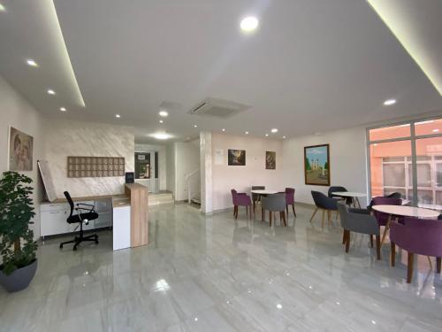 a lobby with tables and chairs in a building at Pansion Maglica in Međugorje