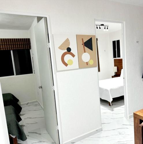 a room with a white door with paintings on it at Departamento en tulum Quintana roo in Tulum