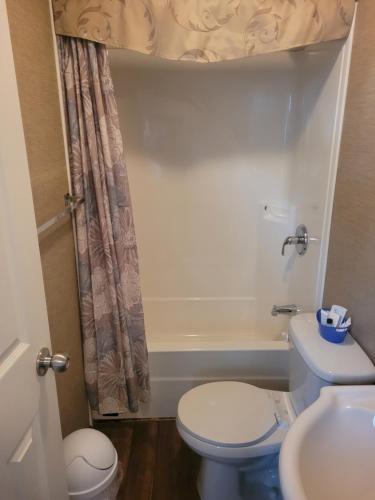 a bathroom with a toilet and a sink at 3 Bedroom Cottage Beachview Lane 35 in Cherry Valley