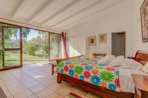 a bedroom with a bed and a large window at Finca Ranchon Grande by Rentallorca in El Port