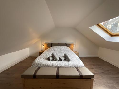 a attic bedroom with a bed with two pillows at La Dame - Centre - Moderne - 2 pers in Le Mans