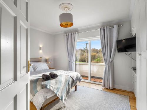 a bedroom with a bed and a window at 1 An tSean Scoil, Clifden in Clifden