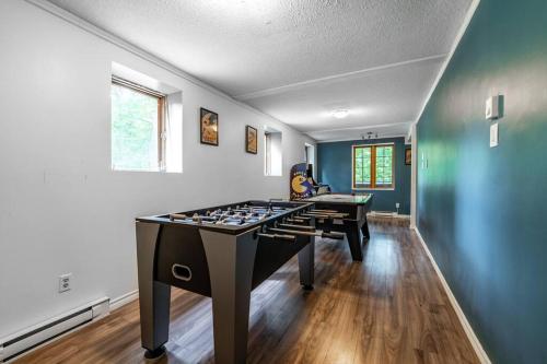 a large game room with a ping pong table at Chalet Mont Cascades w/ Spa & Fibre Optic Internet in Cantley