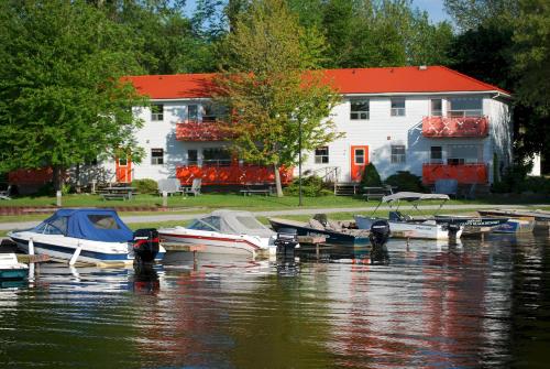 a group of boats in the water in front of a house at 2 Bedroom Harbor Front Condo 11U in Roseneath