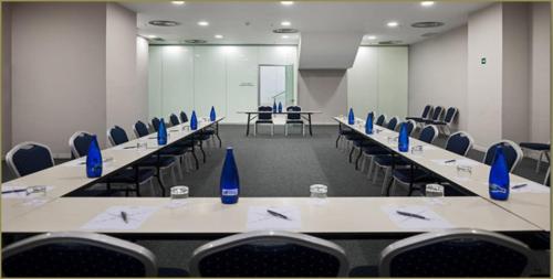 a conference room with rows of tables and chairs at Exe Convention Plaza Madrid in Madrid