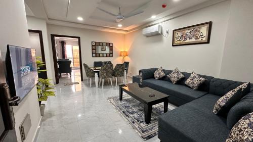 a living room with a couch and a table at Two Bed Luxury Apartment in Islamabad