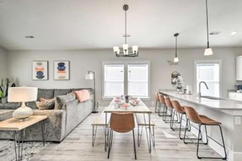 a kitchen and living room with a couch and a table at New Tucked Away Quiet Beach Haven in Little River