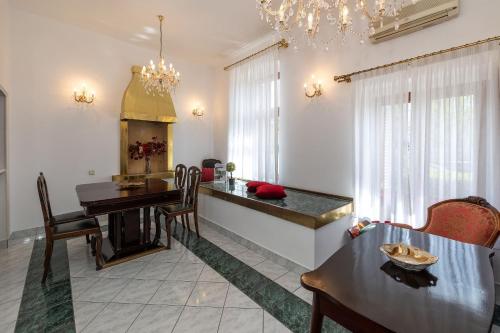 a kitchen and dining room with a table and chairs at Apartments Villa Castello in Crikvenica