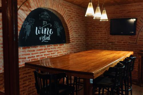 a dining room with a wooden table and chairs at Miravida Soho Hotel & Wine Bar in Buenos Aires