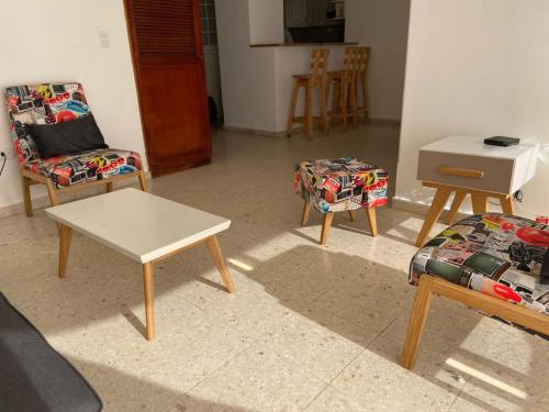 a living room with two chairs and a table at APATAMENTO ALTAMAR DEL CABRERO 703 in Cartagena de Indias