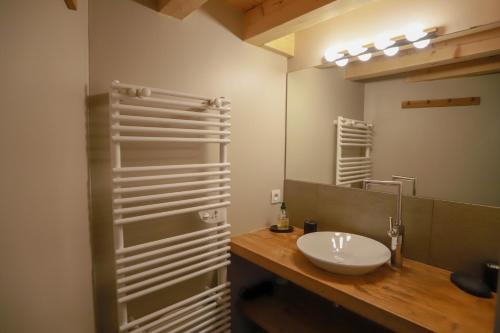 a bathroom with a white sink and a mirror at Nid douillet in Annecy