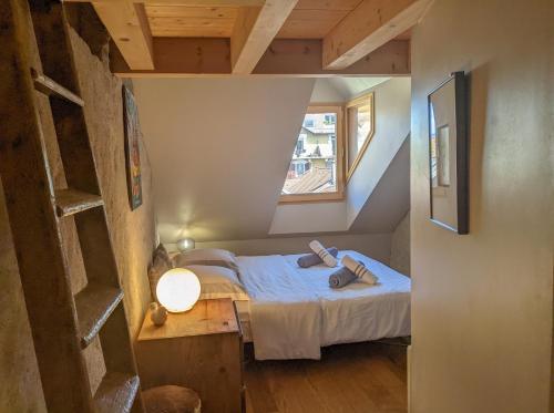 a small bedroom with a bed in a attic at Nid douillet in Annecy