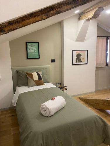 a bedroom with a bed with a towel on it at Affittacamere San Petronio House in Bologna