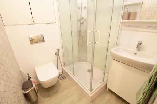 a bathroom with a shower and a toilet and a sink at ELEVANA in Fuengirola