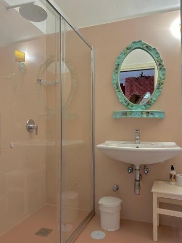 a bathroom with a glass shower and a sink at Carafa di Maddaloni Residenza di Charme in Naples