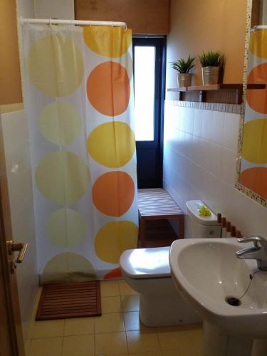 a bathroom with a toilet and a shower curtain at Picasso in Culleredo