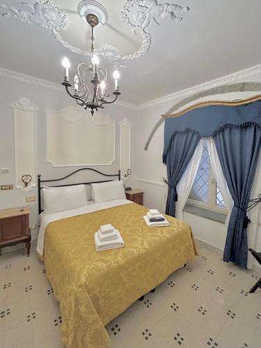 a bedroom with a bed with two towels on it at Carafa di Maddaloni Residenza di Charme in Naples