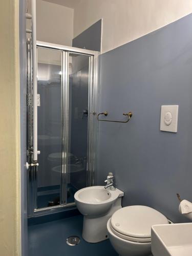 a bathroom with a shower and a toilet and a sink at Carafa di Maddaloni Residenza di Charme in Naples