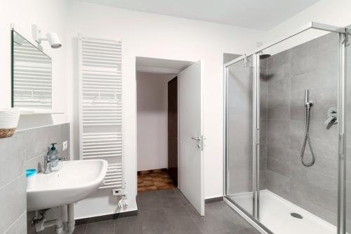 baño blanco con ducha y lavamanos en ORTENSIA APARTMENT, en Bellagio