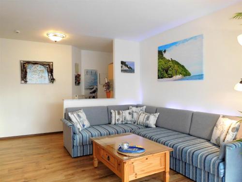 a living room with a couch and a coffee table at Komfortferienwohnung Kreideblick in Sassnitz
