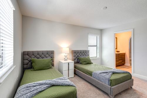 a bedroom with two beds and a window at Near Disney and Legoland Spacious Poolside Oasis! in Haines City