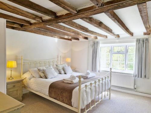 a bedroom with a bed and a large window at The Milk House in Ashurst