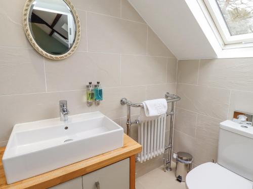 a bathroom with a sink and a toilet at The Fullerton in Longwitton