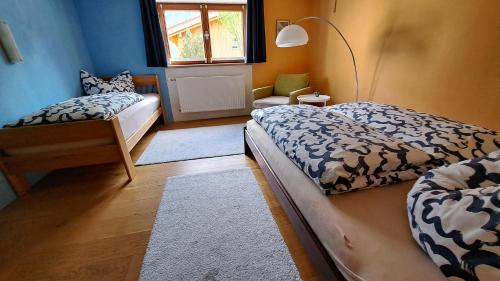 a bedroom with two beds and a window at Ferienwohnung Bär Außerbraz in Innerbraz