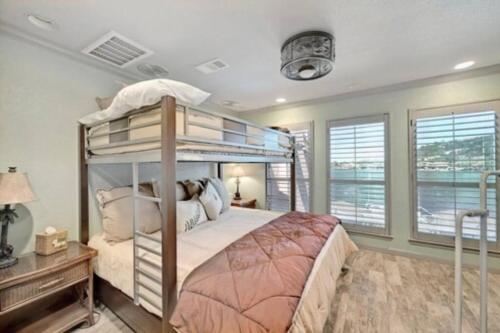 a bedroom with a bunk bed and a window at Stunning Waterfront Property Sleeps 12+ in Horseshoe Bay