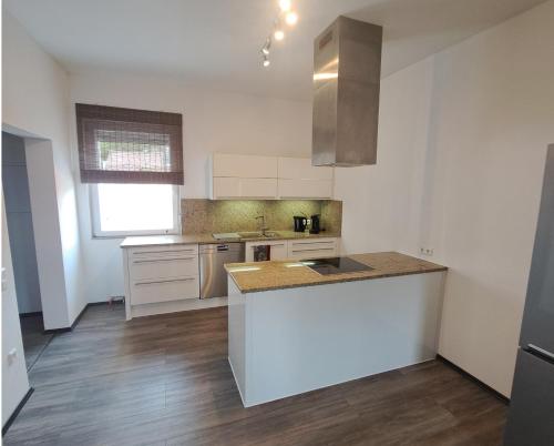 a kitchen with white cabinets and a counter top at Ferienwohnung Paulus in Albstadt