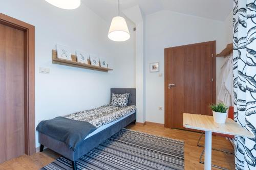 a small room with a bed and a table at Medical Spa Kwiatowa in Łęczyca