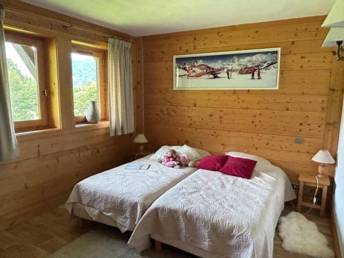 a little girl laying on a bed in a bedroom at Chalet familial sur les pistes in Megève