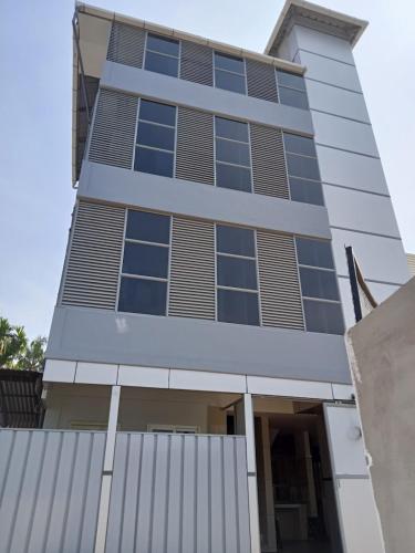 a tall building with a lot of windows at Jalaliyaa residency in Cochin