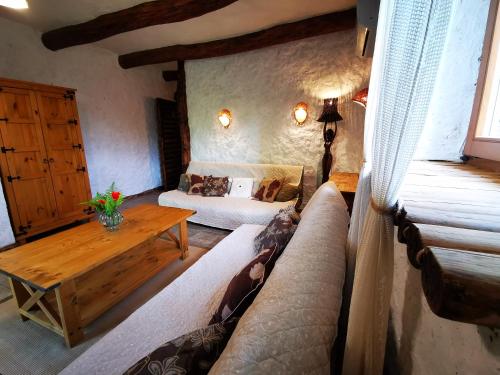 a living room with a couch and a table at Kraina Alkos - Adults Only (18+) in Iznota