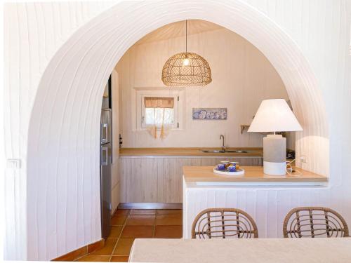 an archway in a kitchen with a table and chairs at BGItalianVacation - Ville Li Conchi in Castiadas