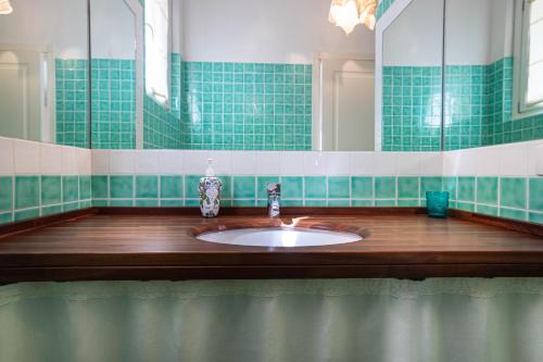 a bathroom with a sink and a mirror at BGItalianVacation - Ville Li Conchi in Castiadas