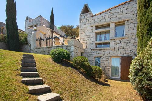 a stone house with a pathway leading up to it at BGItalianVacation - Ville Li Conchi in Castiadas