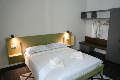 a bedroom with a large bed with towels on it at La Marina - Casa Assuntina in Letojanni
