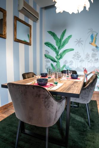 a dining room with a wooden table and chairs at Art Maison in Vacallo