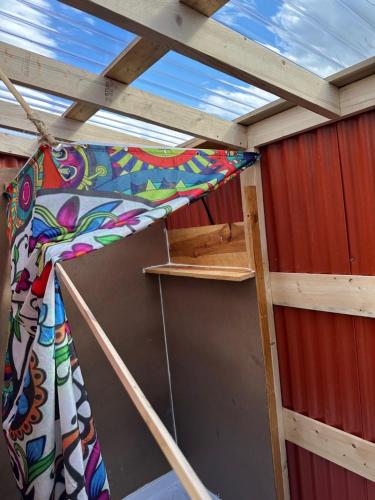 a bunk bed in a room with a roof at Infidel Acres Motorcycle Campground in Naches