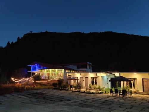 a house at night with lights in front of it at BN Resort in Gangolihāt