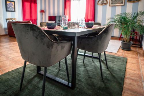 a dining room table with two chairs and a table with glasses on it at Art Maison in Vacallo