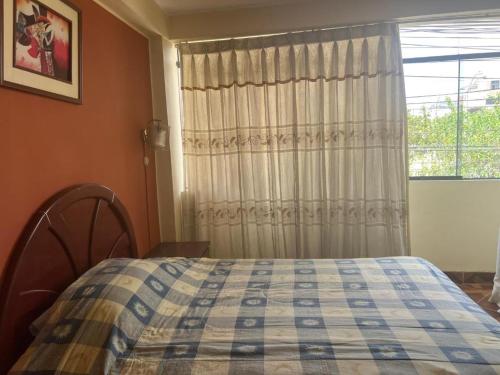 1 dormitorio con cama y ventana en HOTEL ARC&SUITE, en Tacna
