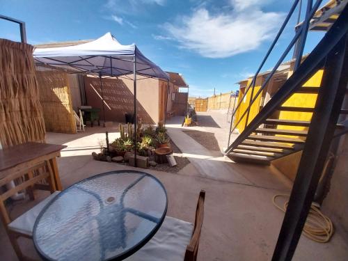 a glass table sitting on the ground next to a staircase at Casa Ñawi in San Pedro de Atacama