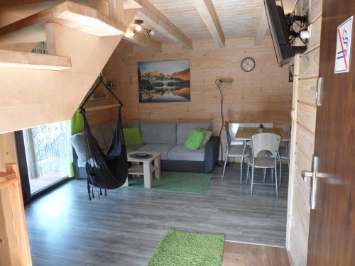 a living room with a couch and a table at Domki pod Pilskiem in Korbielów
